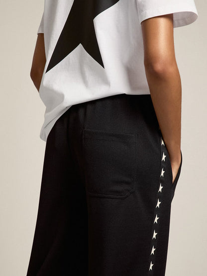 Women’s black joggers with white stars on the sides